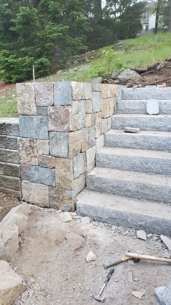 Granite steps with a fieldstone retaining wall